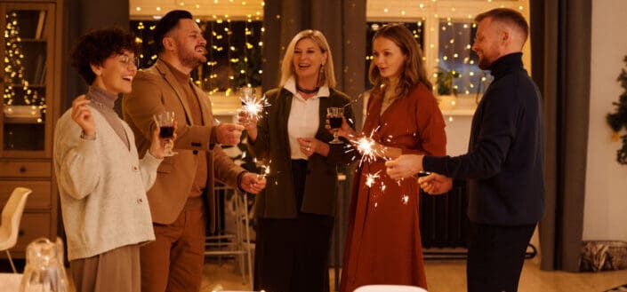 group of people holding wine and sparklers