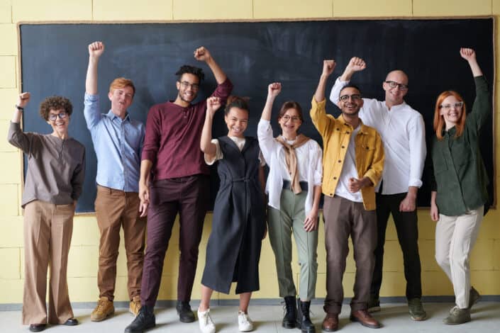 group of happy people with their fists up