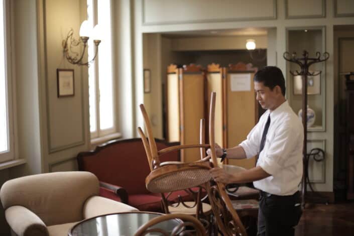 a man setting down chairs