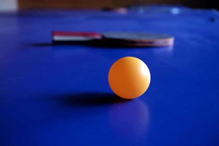 pingpong ball with a paddle behind it