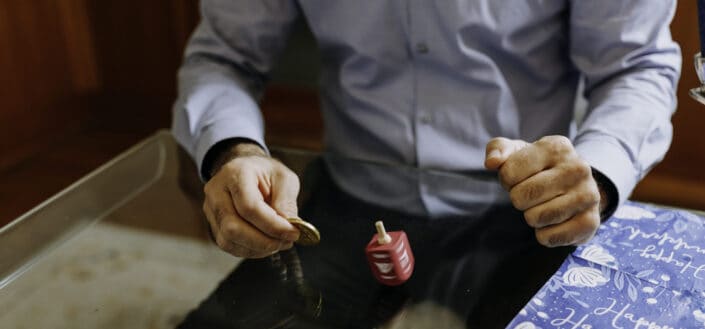 man holding a coin on a table