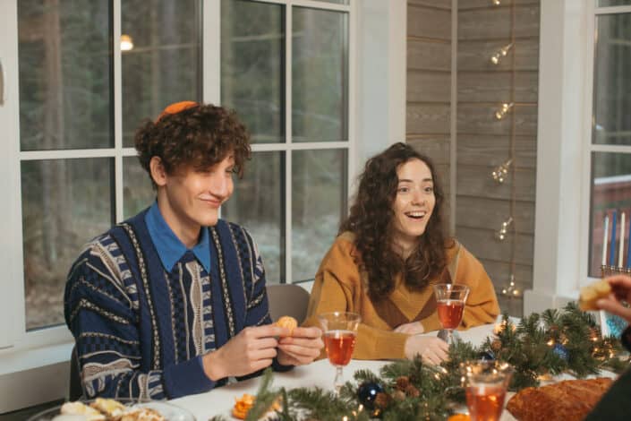 couple smiling at someone they're talking to