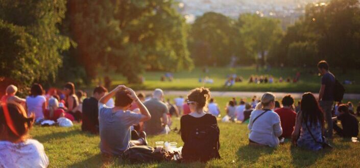 Group of people enjoying music concert in open field