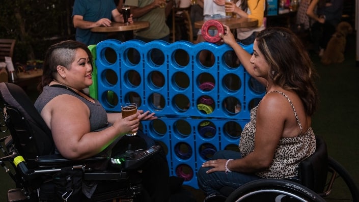 two women on wheelchairs playing a game