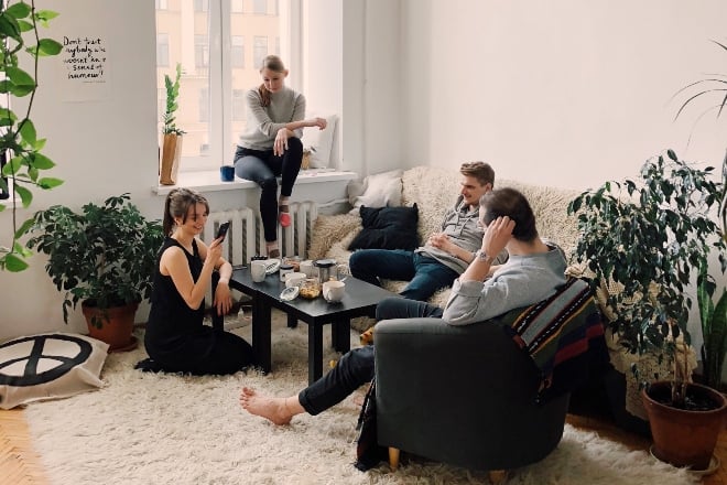 people hanging out in living room - Christmas Party Games For Adults