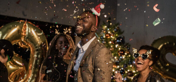 three people at a party surrounded by confetti