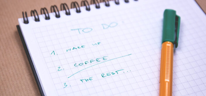 notebook with a to-do list and a pen