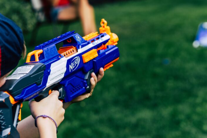 a boy aiming a nerf gun