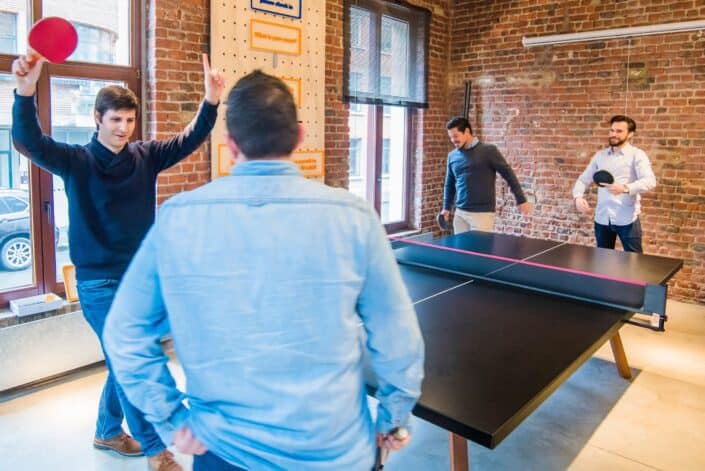 four men playing pingpong 