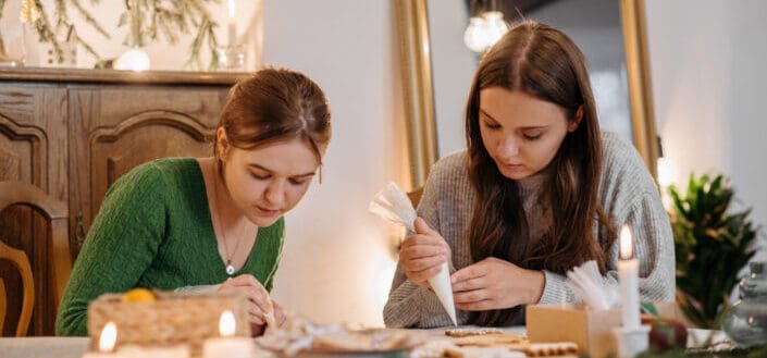 two women piping cookies