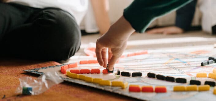 Person holding yellow and red plastic toy