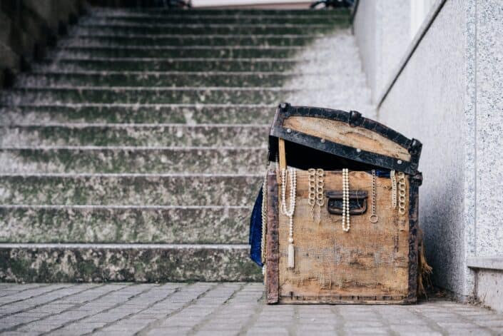 slightly open treasure chest at the foot of a flight of stairs