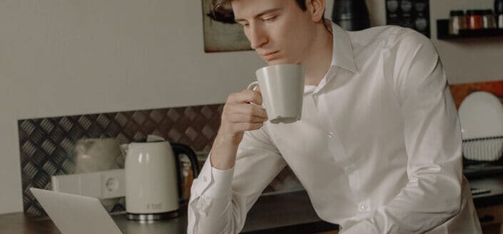 man drinking coffee from a mug
