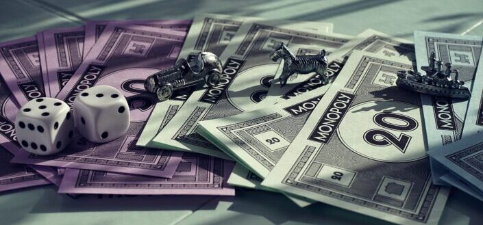 monopoly characters with dice and monopoly currency