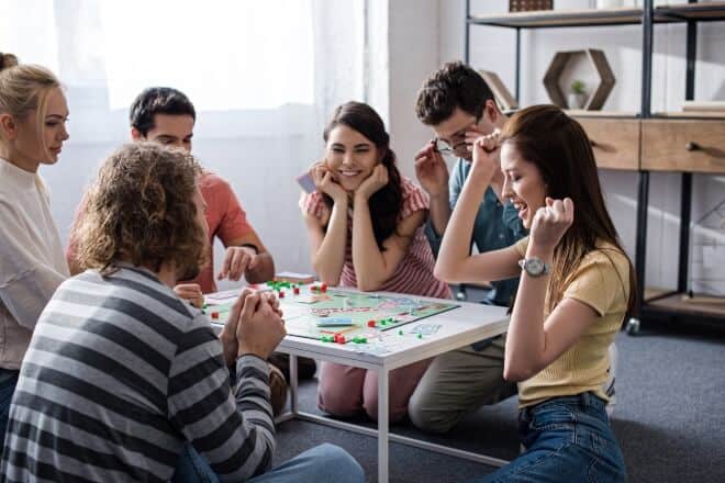 A group of people happily playing - Funny Board Games