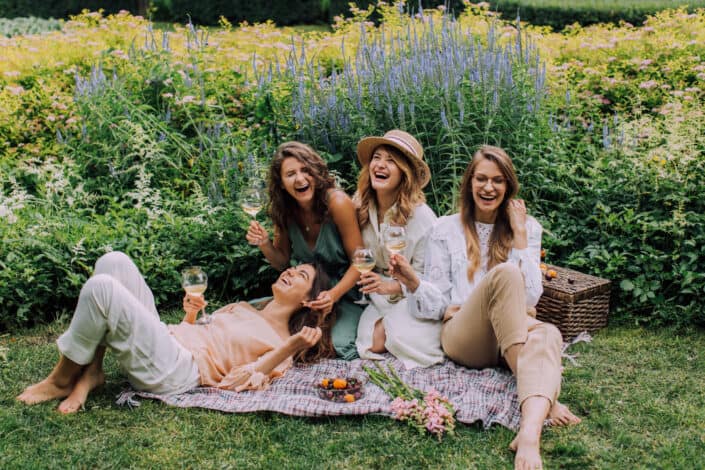 four ladies having a fun picnic outside