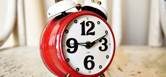 a red, vintage alarm clock
