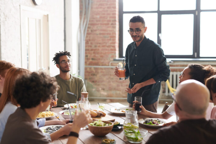 friends around the table, eating while chatting