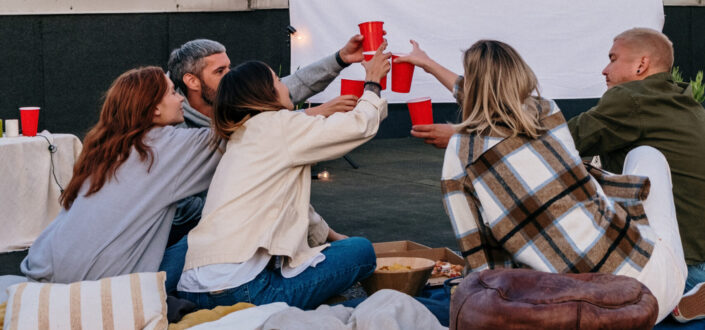A group of friends clinking their glasses together