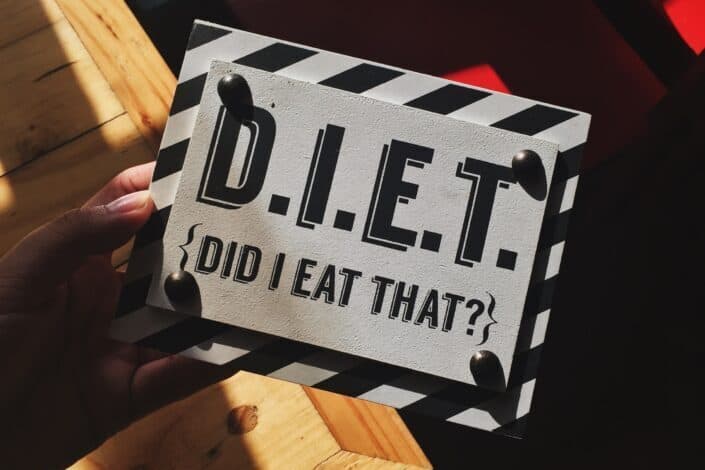 person holding DIET quote board