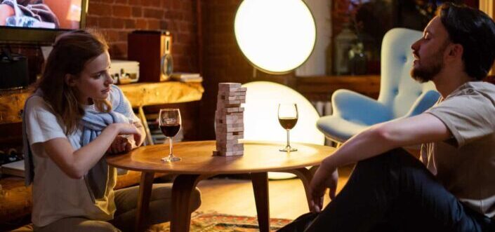 Couple playing jenga on a round table