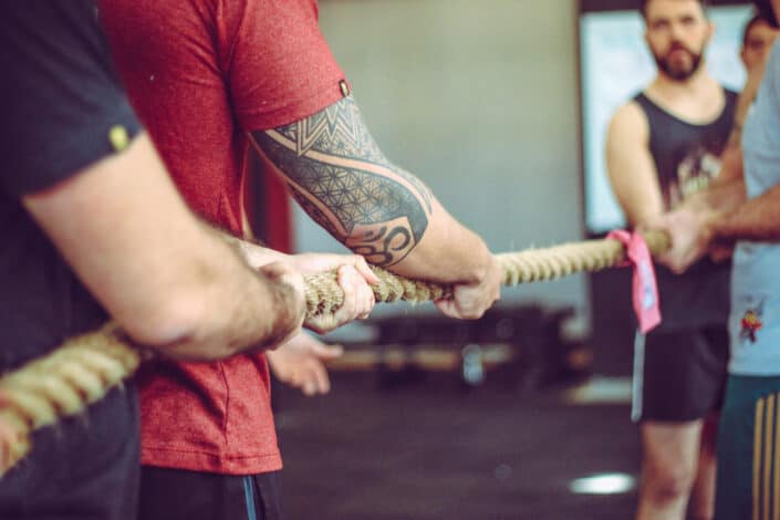 Friends playing tug-of-war indoor