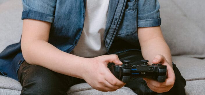Kid sitting on a couch playing video games