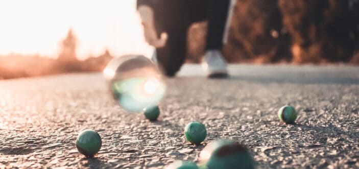 Kid throwing his marbles on the ground