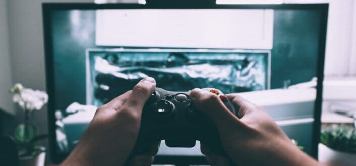A guy playing video game with his playstation