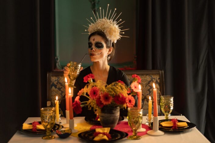 Woman dressed up for Halloween, drinking