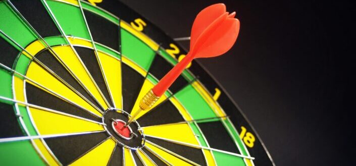 Red and Brass Darts Pin on Dartboard