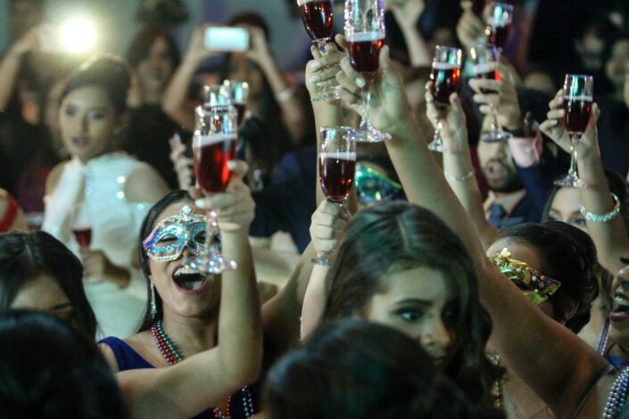 Women in masquerade party toasting to each other