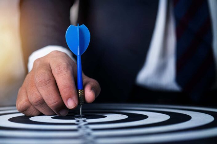 Person Holding Blue Darts Pin