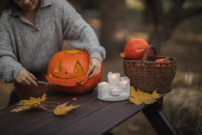 Woman carving a pumpkin