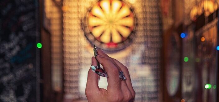 Person Aiming on Dartboard