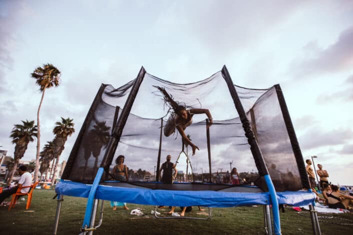 Anonymous athlete jumper bouncing on trampoline