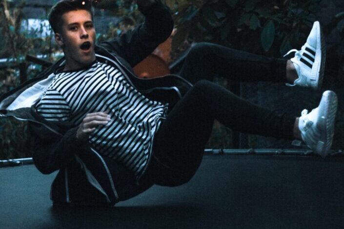 man jumping on black trampoline
