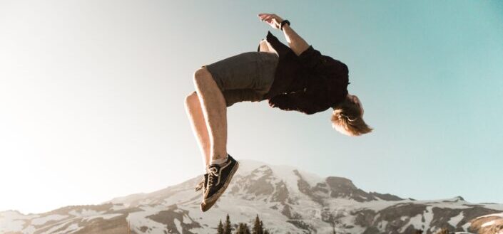 man back tumbling on cliff