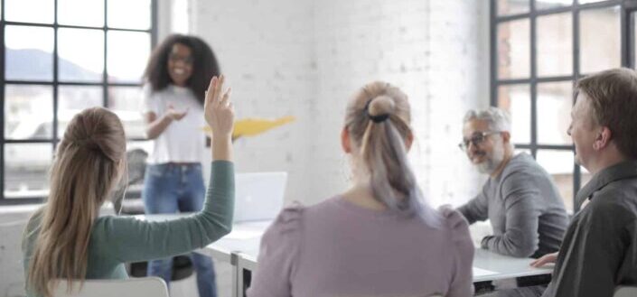 Employee Raising Her Hand at a Conference