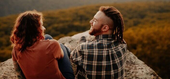 Man and Woman Sitting by a Cliff