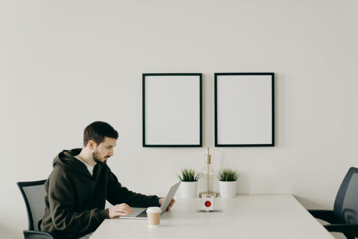 Man in Black Long Sleeve Shirt Working at the Table