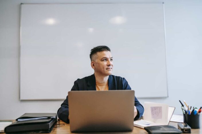 Man Staring Out the Window While Working