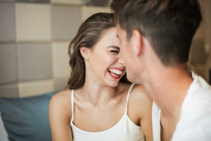 Woman in Strap Tank Top Laughing Next to a Man