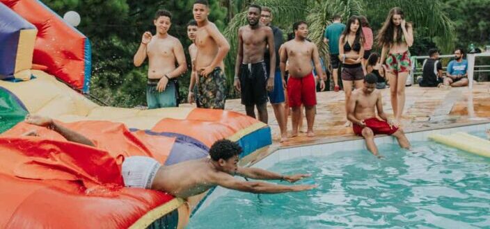 A man sliding on an inflatable slide