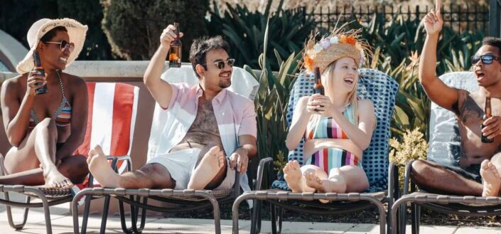People raising their beer bottles