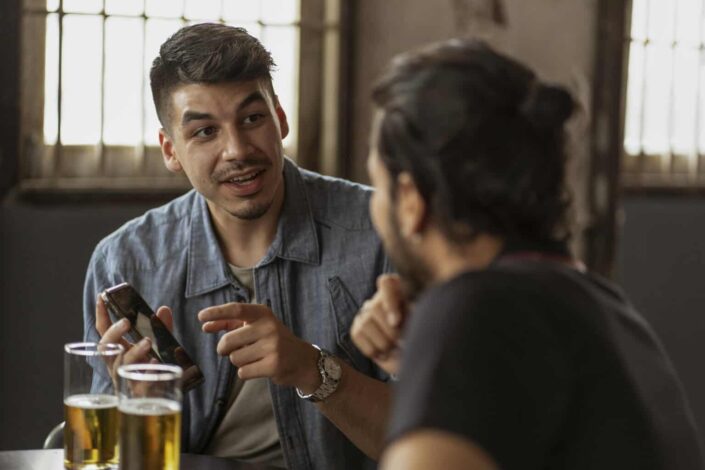 Man Showing His Phone to His Friend