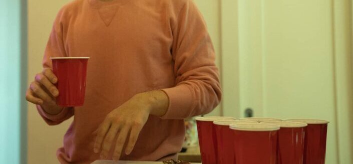 Man With Red Plastic Cups at Party