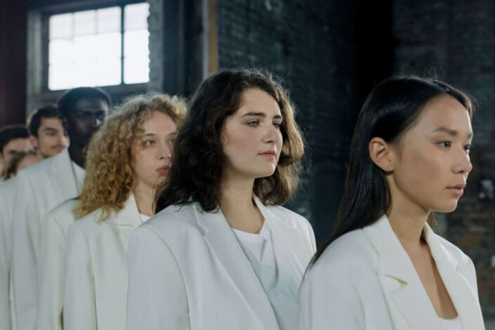 People Lined Up in White Outfits