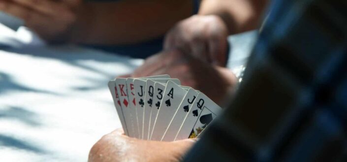 Man Holding His Cards