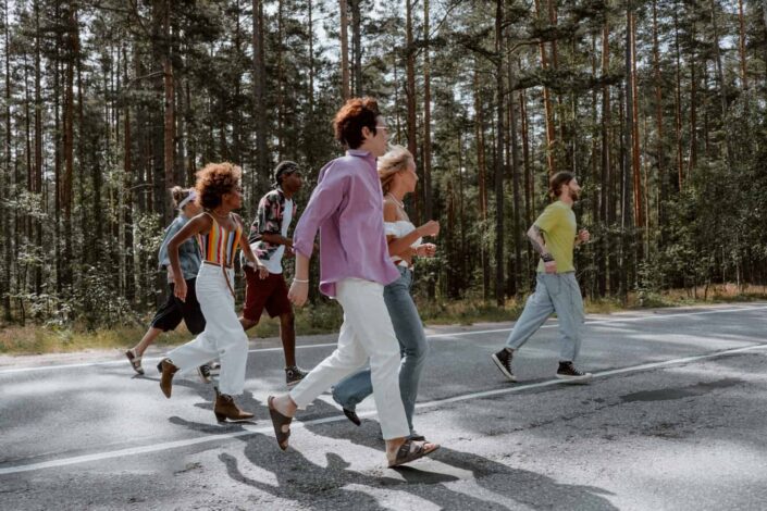People Running on Gray Asphalt Road